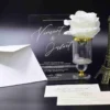 Modern clear acrylic invitation featuring elegant white script text, part of a minimalist wedding invitation suite with mailing envelopes.