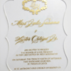 A transparent acrylic wedding invitation with a custom-contoured, wavy scalloped edge. The invitation is presented on a clean white background.