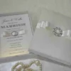Ivory wedding invitation box suite featuring foil stamp details on pearl shimmery cardstock with a silk card holder.