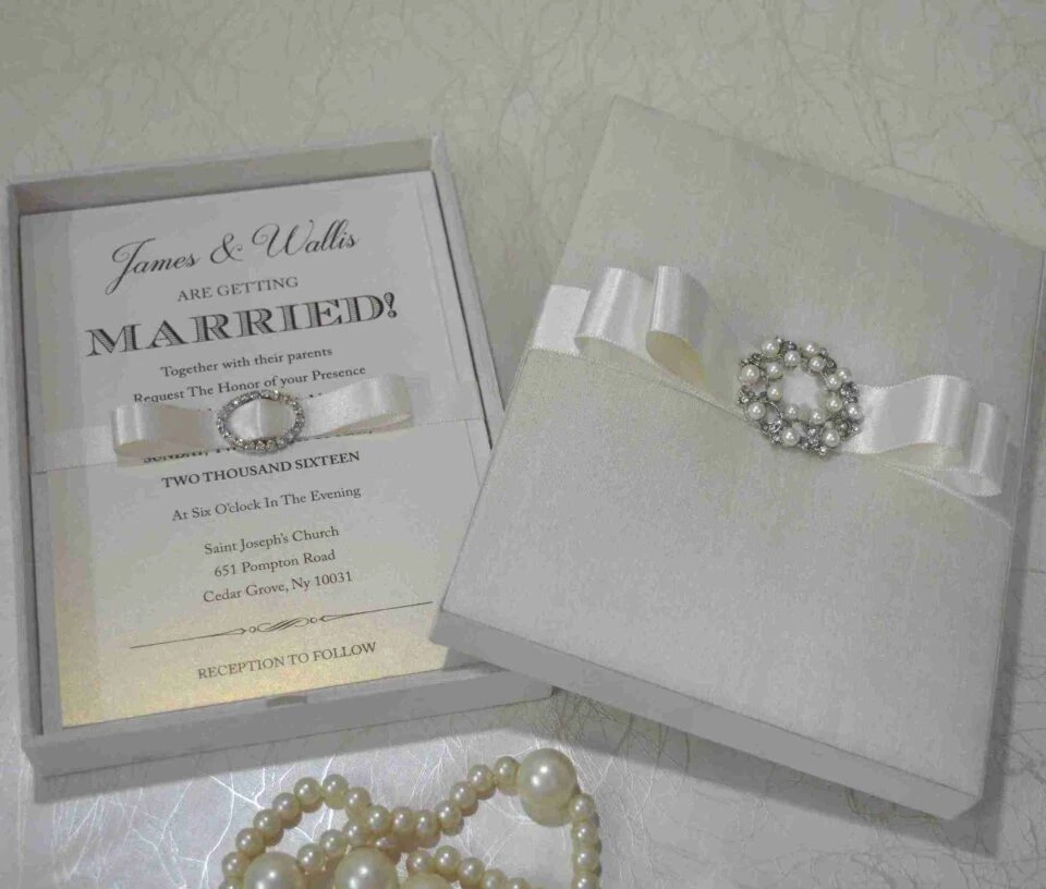 Ivory wedding invitation box suite featuring foil stamp details on pearl shimmery cardstock with a silk card holder.