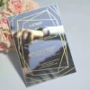 Luxury silver mirror acrylic wedding invitation featuring a geometric border and custom gold silk screen printing.