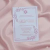 A vertical invitation for a Bat Mitzvah, printed in rose gold foil on a light lavender or White acrylic card. The card features a Star of David at the top and is framed by delicate floral flourishes in the corners and a dotted border.