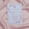 A vertical invitation for a Bat Mitzvah, printed in rose gold foil on a light lavender or White acrylic card. The card features a Star of David at the top and is framed by delicate floral flourishes in the corners and a dotted border.