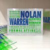 A vibrant, modern birthday invitation for printed on a shimmering silver glitter background. The design features a bold, blocky typography layout in alternating electric green and royal blue. The text invites guests to "Celebrate the Glowing Up" of the birthday boys and includes event details like dinner, dancing, and formal attire, alongside a QR code in the bottom right corner. Several other clear acrylic and glitter invitations are scattered on a light wood surface in the background.