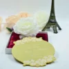 This image showcases a luxurious gold mirror acrylic wedding invitation with a unique, scalloped circular shape. It is positioned in front of an open white box lined with rich burgundy satin, which holds a large, white Box.