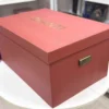 Burnt orange top & bottom bridal lehenga box with gold foil logo. Box is made from rigid 7mm MDF & equipped with premium antique gold handles.