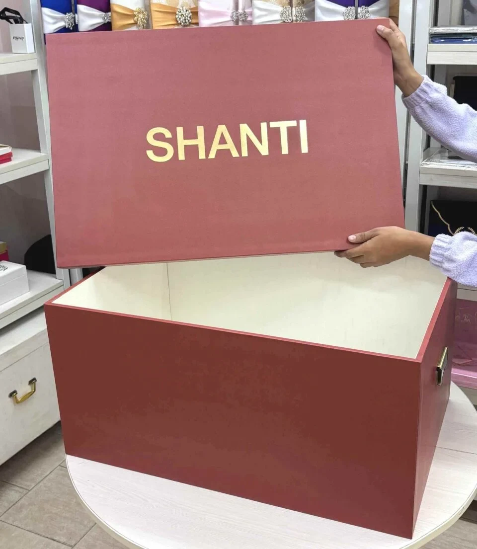 Burnt orange top & bottom bridal lehenga box with gold foil logo. Box is made from rigid 7mm MDF & equipped with premium antique gold handles.