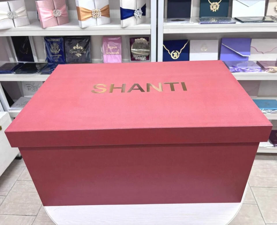Burnt orange top & bottom bridal lehenga box with gold foil logo. Box is made from rigid 7mm MDF & equipped with premium antique gold handles.