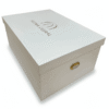 Luxury bridal lehenga box crafted from 7mm MDF featuring a white pearl shimmer finish, custom gold foil branding for a fashion designer, and premium side handles for couture trousseau packaging.