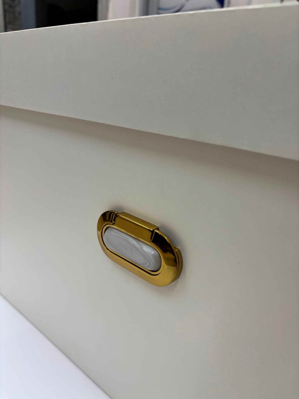 Luxury bridal lehenga box crafted from 7mm MDF featuring a white pearl shimmer finish, custom gold foil branding for a fashion designer, and premium side handles for couture trousseau packaging.