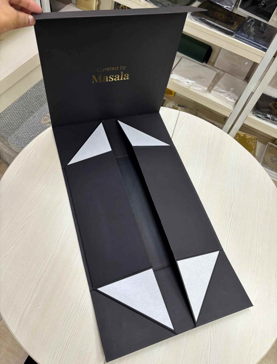 Flat-pack foldable rigid box design for luxury packaging storage.