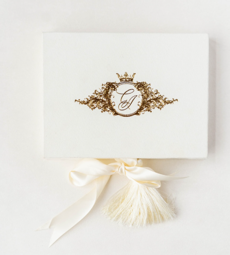 chateau challain wedding invitations made from Ivory velvet with gold foil crown monogram and satin ribbon and silk tassel